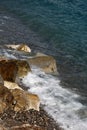 Sea waves hit stony seashore