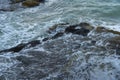 Sea waves lash line impact rock on the beach