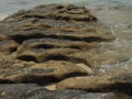 Sea waves lash line impact rock on the beach