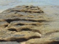 Sea waves lash line impact rock on the beach