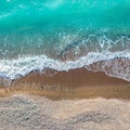 Sea waves over sand and pebbles beach, top view directly above