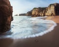 Sea Waves at Praia Dona Ana Beach and Rock formations at sunrise - Long Exposure shot - Lagos, Algarve, Portugal Royalty Free Stock Photo