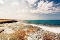 Sea waves and rocks at sunset, creamy water and clear skies on a beautiful summer day Royalty Free Stock Photo