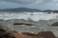 Sea waves roll over the rocks