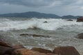 Sea waves roll over the rocks