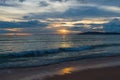 sea waves roll on a sandy beach in the evening during a beautiful sunset Royalty Free Stock Photo