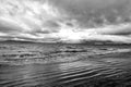 Sea waves on sandy beach in reykjavik, iceland. Seascape with grey water on cloudy sky. Power of nature. Wanderlust or