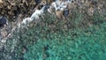 Sea waves spashing on rocky coast. Drone footage of sea and rocky land