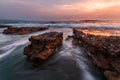 Sea waves splashing over the rocks at sunset, Mollymook, NSW South Coast, Australia