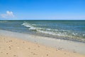 Sea waves wash the beach against a blue sky. Landscape on a wild beach. The sea in the summer Royalty Free Stock Photo