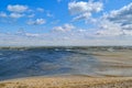 Sea waves wash the beach against a blue sky. Landscape on a wild beach. The sea in the summer Royalty Free Stock Photo