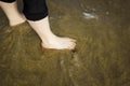 Sea waves wash female feet Royalty Free Stock Photo