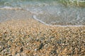 Sea waves washed clean beach made of shells Royalty Free Stock Photo