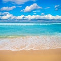 Sea waves white foam over golden beach sand