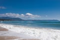 Sea waves and white foam in paradise sandy beach, blue sky, on sunny summer day. Royalty Free Stock Photo