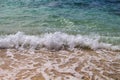 Sea with white wave splashing over beach. Waving sea. Clear turquoise blue sea water over sand beach. Royalty Free Stock Photo