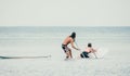 Sea woman and man on sup. Silhouette of happy young woman and man, surfing on SUP board, confident paddling through