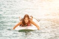 Sea woman sup. Silhouette of happy young woman in pink bikini, surfing on SUP board, confident paddling through water Royalty Free Stock Photo