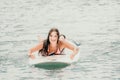 Sea woman sup. Silhouette of happy young woman in pink bikini, surfing on SUP board, confident paddling through water Royalty Free Stock Photo