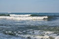 The sea is worry, waves with foam. The white ships on the horizon Royalty Free Stock Photo