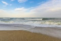 A city beach. A turbulent sea washes footprints in the sand. Benalmadena, Malaga, Andalusia, Spain Royalty Free Stock Photo