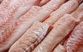 Seabass, hamour, grouper fish, sea bass fillet many pieces sliced piled bulk in fish market Royalty Free Stock Photo