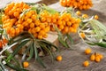 Seabuckthorn berries branch on vintage wooden background. Autumn background