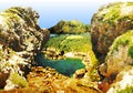 Seacoast with rocks, creek and mountains