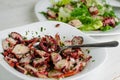 Seafood appetizer. Octopus salad cooking process. Mediterranean delicacy. Selective focus, close up