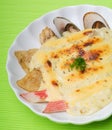 Seafood baked with cheese, seafood gratin