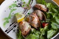 seafood baked in cream sauce and mussel cheese with vegetables on a white plate in a restaurant