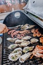 Seafood BBQ  barbecue. Collection of octopus, oysters, clam, tiger shrimps grilled on grill Royalty Free Stock Photo