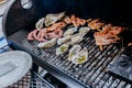 Seafood BBQ  barbecue. Collection of octopus, oysters, clam, tiger shrimps grilled on grill Royalty Free Stock Photo