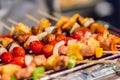 Seafood and beef barbecue BBQ skewered on bamboo sticks with pie apple, tomato, onion and chili are grilling on the stove for ba Royalty Free Stock Photo