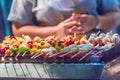 Seafood and beef barbecue BBQ skewered on bamboo sticks with pie apple, tomato, onion and chili are grilling on the stove for ba Royalty Free Stock Photo