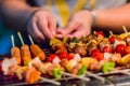 Seafood and beef barbecue BBQ skewered on bamboo sticks with pie apple, tomato, onion and chili are grilling on the stove for ba Royalty Free Stock Photo