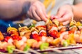 Seafood and beef barbecue BBQ skewered on bamboo sticks with pie apple, tomato, onion and chili are grilling on the stove for ba Royalty Free Stock Photo