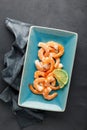 Seafood. Boiled shrimp in a plate on a black background. Royalty Free Stock Photo