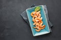 Seafood. Boiled shrimp in a plate on a black background. Royalty Free Stock Photo