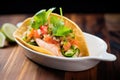 seafood chalupa with shrimp and lime wedge