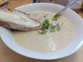 Seafood chowder with soda bread served in a white bowl Irish meal