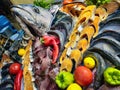 Seafood decoration with raw salmon, tuna, sea bream and other fish arranged with vegetables on ice in display of the restaurant Royalty Free Stock Photo