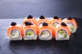 Seafood delicatessen salmon sushi rolls on slate Royalty Free Stock Photo