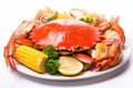 Seafood dish: boiled crabs, shrimp and corn on a white background