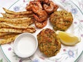 Seafood Feast With Crab Cakes, Spiced Shrimp, Baked Fries, Lemon and Horse Radish Sauce Royalty Free Stock Photo