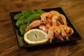 Seafood. Fried roasted shrimps in plate with lemon and greens herbs Royalty Free Stock Photo