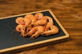 Seafood. Fried roasted shrimps in plate with lemon and greens herbs Royalty Free Stock Photo