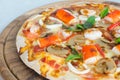 Seafood Italian Pizza slice on wood dish