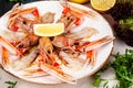 Seafood. Langoustine, scampi or Norway lobster with lemon on white plate