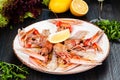 Seafood. Langoustine, scampi or Norway lobster with lemon on white plate Royalty Free Stock Photo